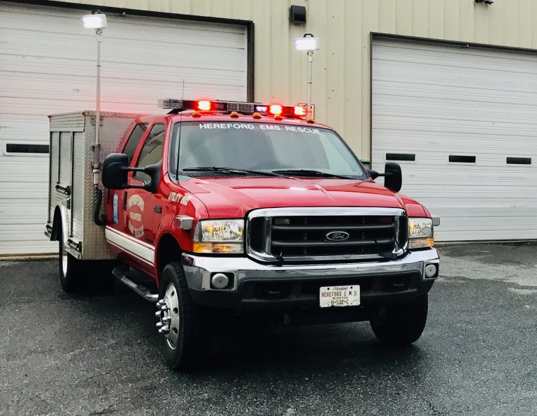 A red truck with lights on top.